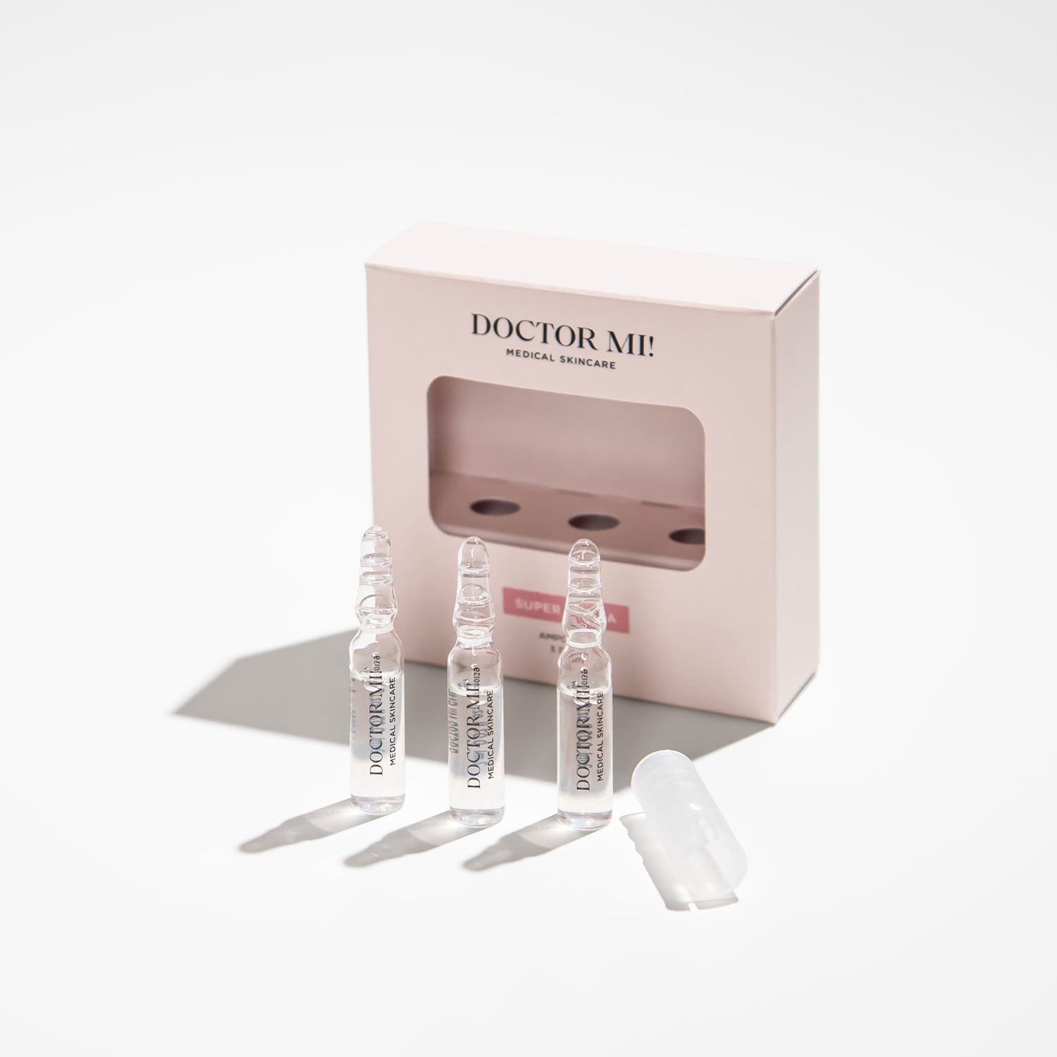 DOCTOR MI! SUPER HYDRA AMPOULES intensive Feuchtigkeit Ampullen für eine starke Hautbarriere und intensive Pflege in weißer Verpackung mit Glasampullen auf grauem Hintergrund